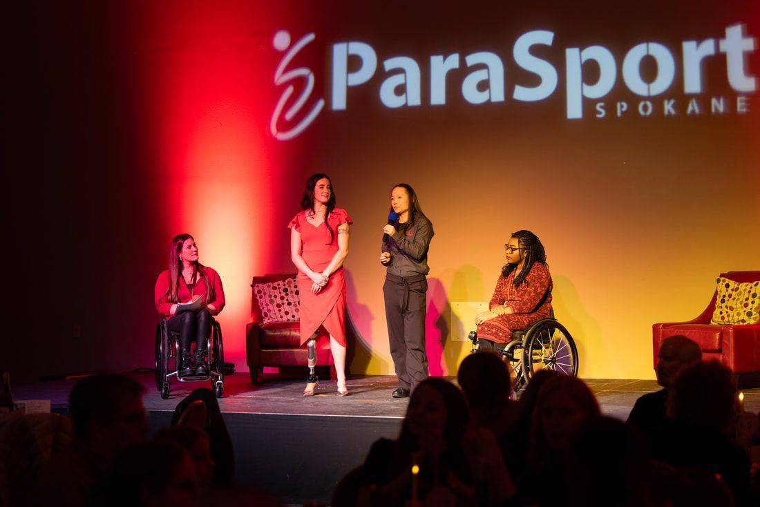 Four women speak on stage at Pairing with ParaSport 2025, two in wheelchairs