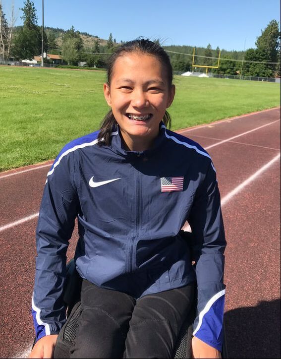 Hannah Dederick smiles in a Team USA jacket on the track