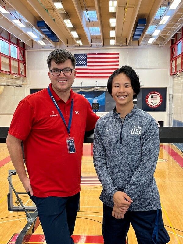 Fencing athlete and coach pose at the USOPC Training Center