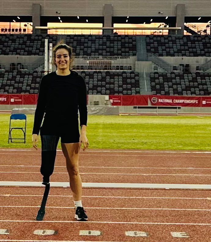 Sprinter with a prosthetic leg stands on the track at the US Para nationals