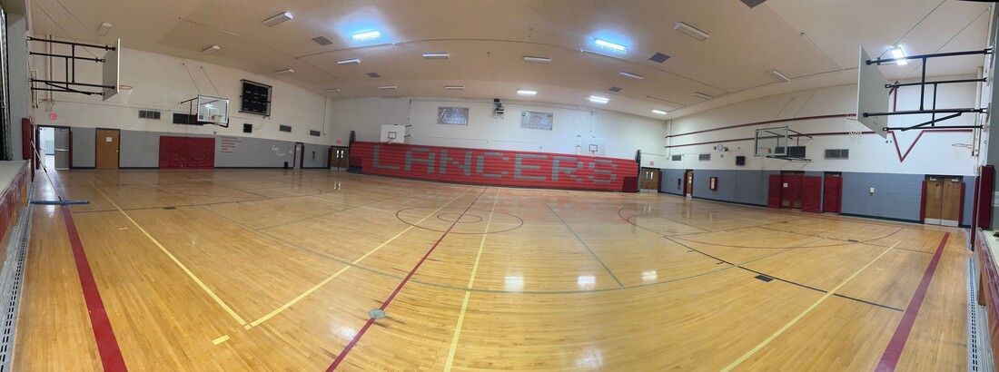 Gym at the former Mountain View Middle School with a wood basketball court