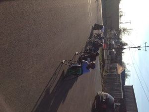 Racer in a racing wheelchair on a street in low morning sun