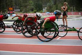 Wheelchair racers speed around the track at the Pine Cone Classic