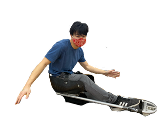Sled hockey player in a red face mask leans sideways in his sled