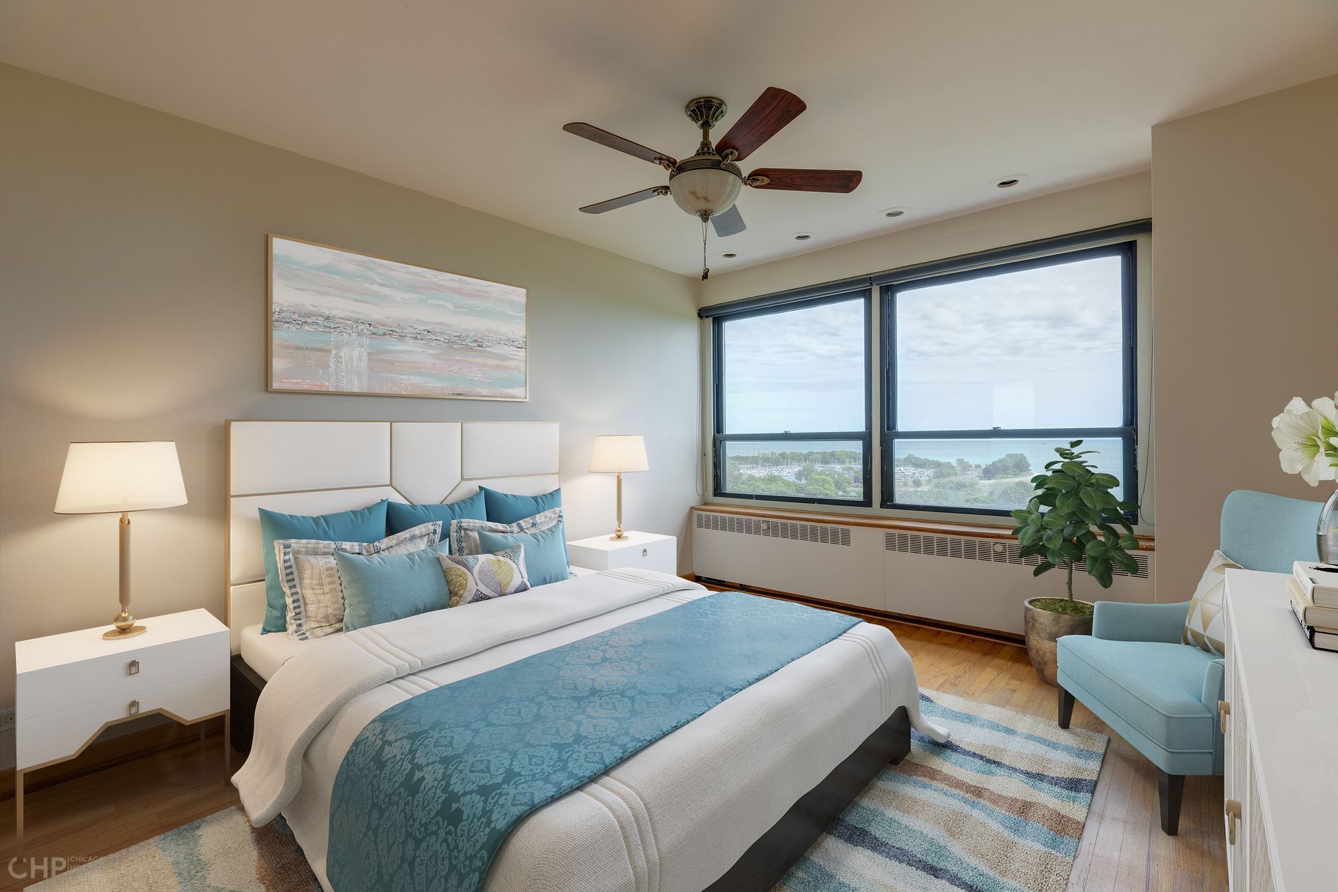 A bedroom with a large bed and a ceiling fan.