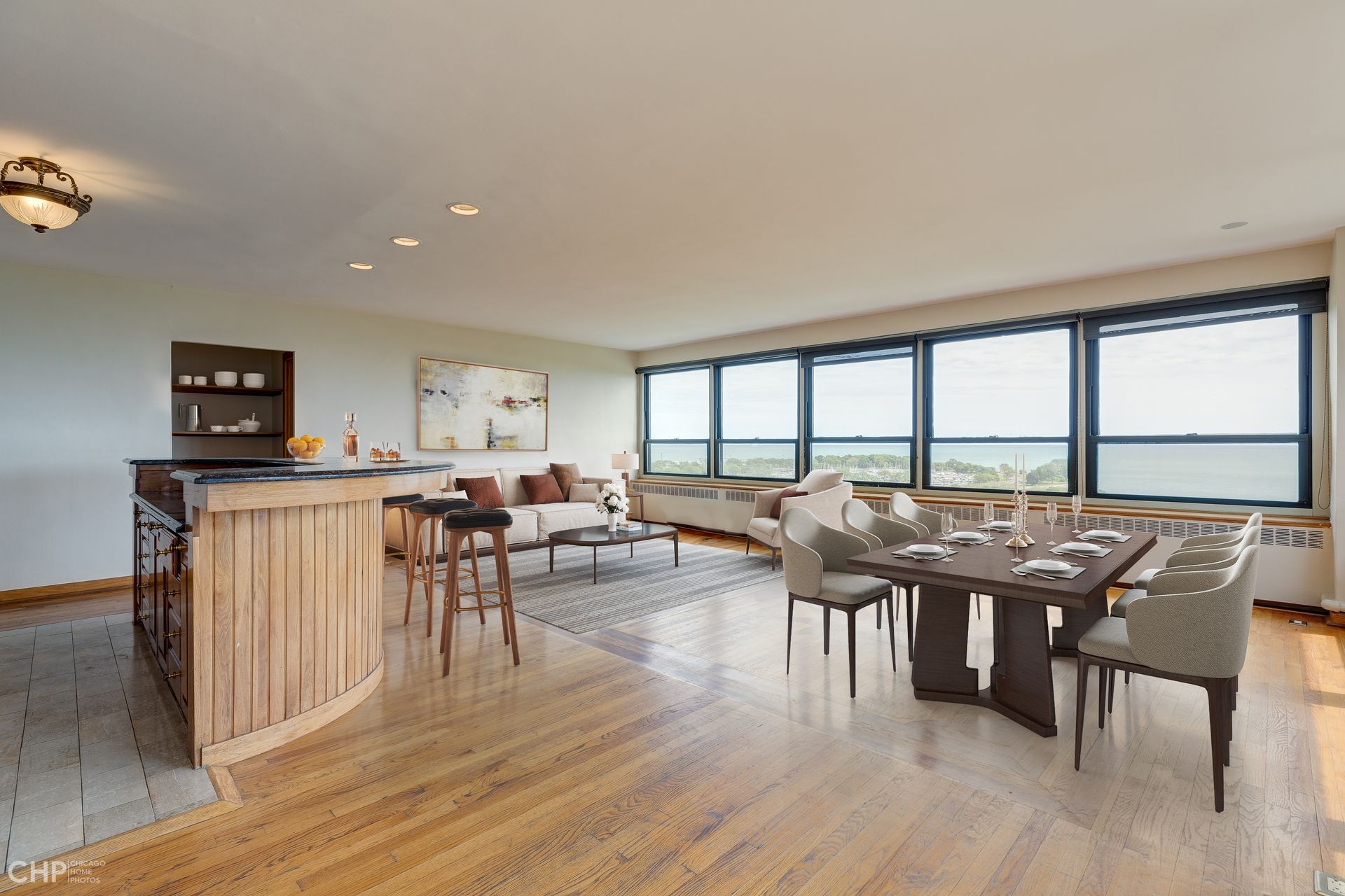A living room with a dining table and chairs and a bar