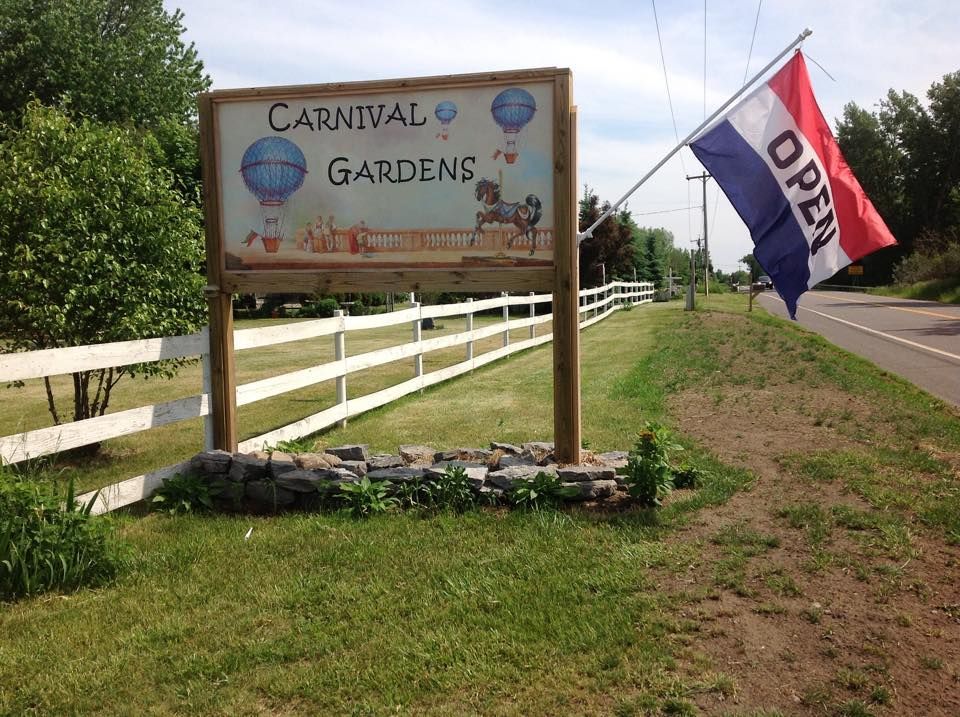 Carnival Gardens Antiques and Art storefront sign in Henderson NY