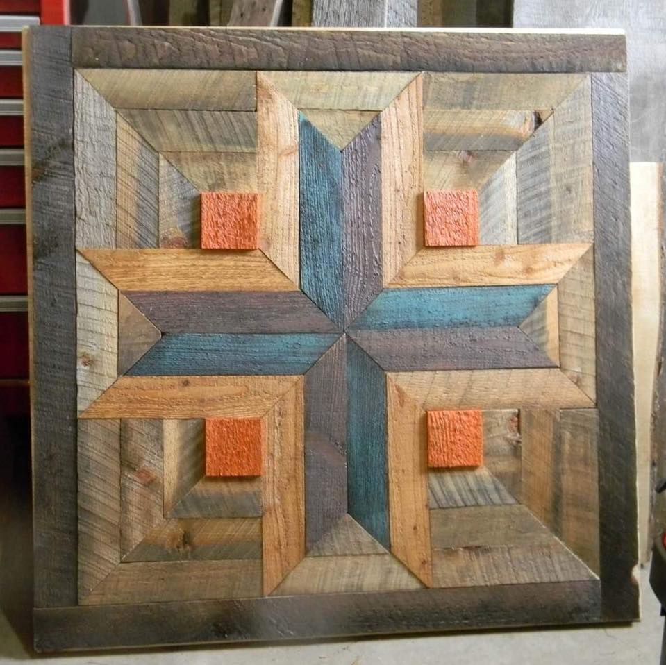 Square geometric wooden wall art with blue, tan, and orange interlocking blocks