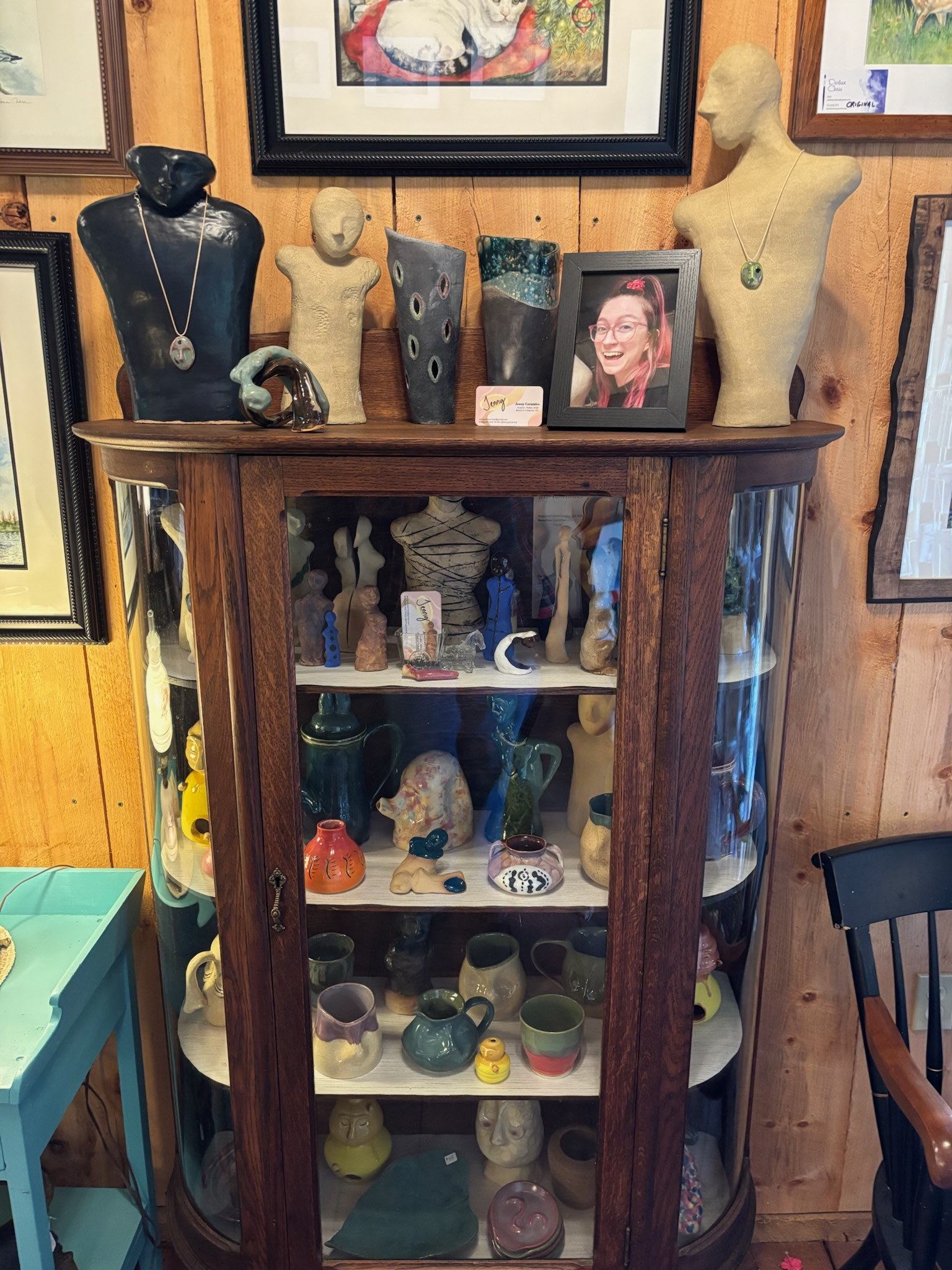 Glass display cabinet filled with Pottery art by Jenny VanWormer