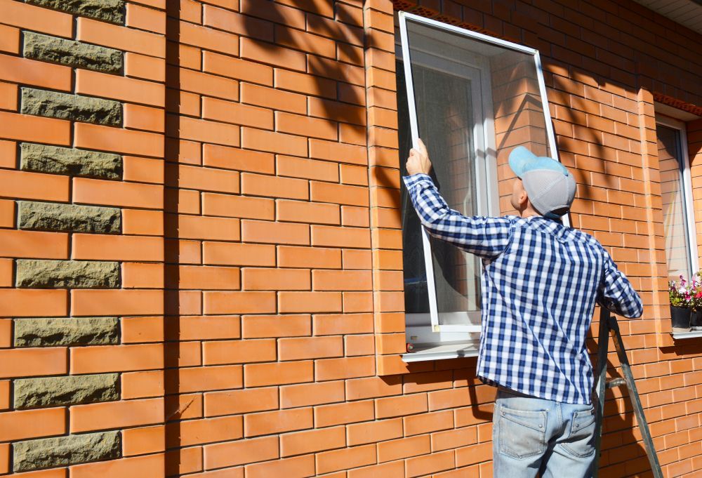 Worker Installing Mosquito Wire Screen — Coastal Screens & Glass in Laurieton, NSW