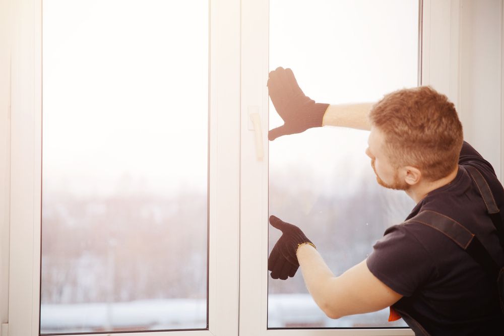 Worker Man Install Plastic Windows and Doors — Coastal Screens & Glass in Bonny Hills, NSW