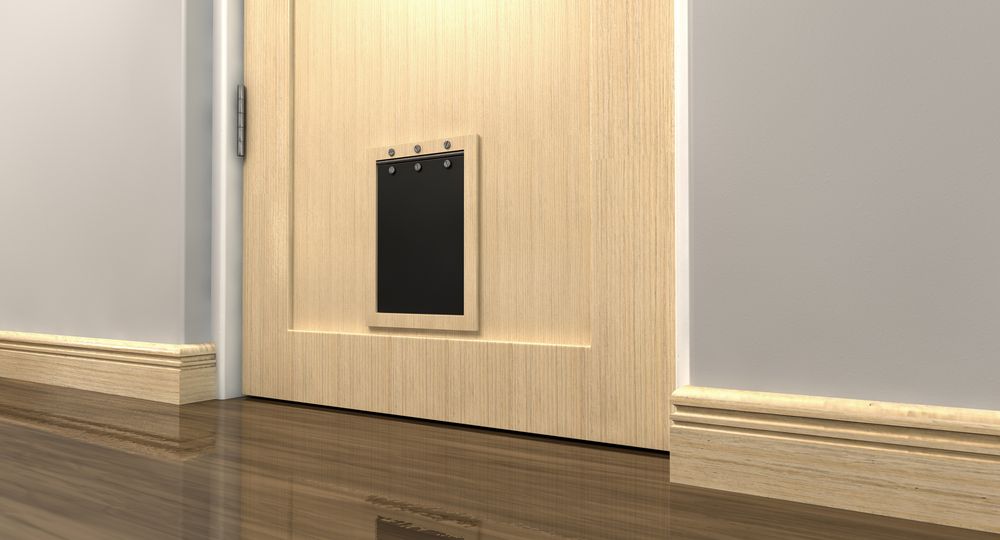 A Inside View of a Regular Black Pet Flap on a Light Wood — Coastal Screens & Glass in Bonny Hills, NSW