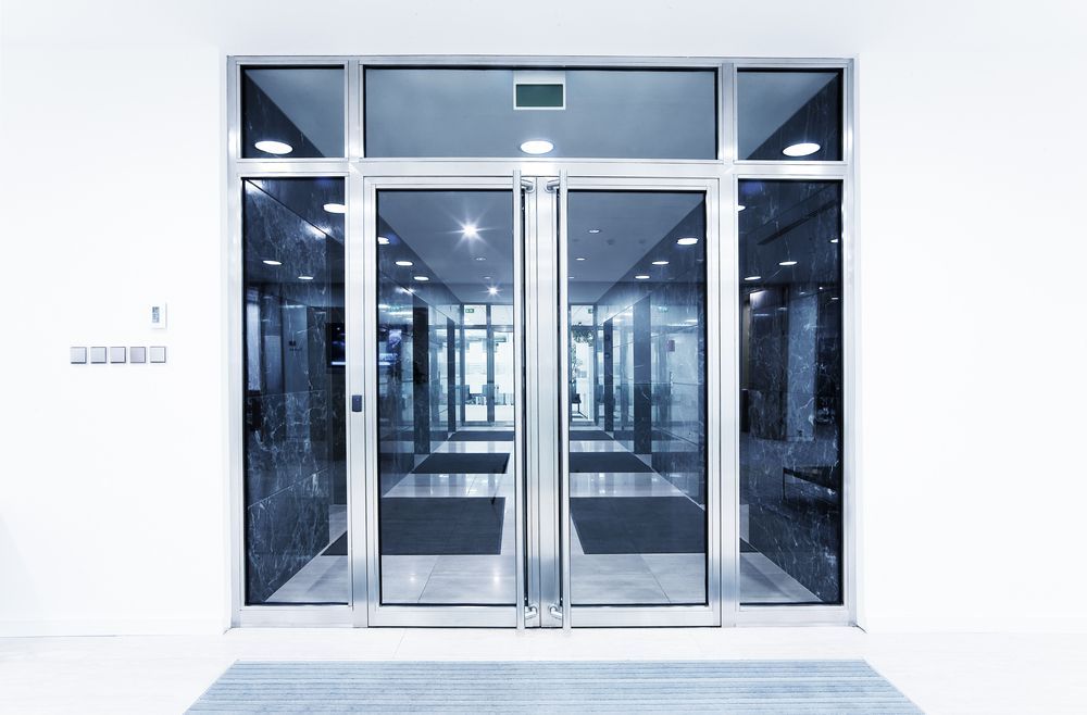 Glass Doors With Blue Tilt — Coastal Screens & Glass in Laurieton, NSW