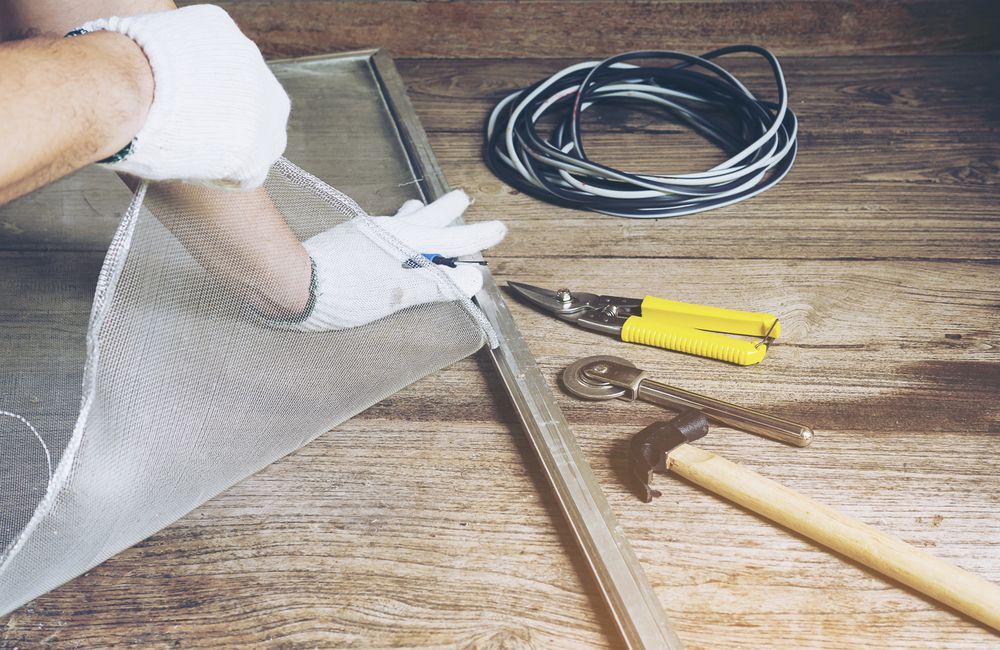 Man is Working With Mosquito Wire Screen — Coastal Screens & Glass in Wauchope, NSW