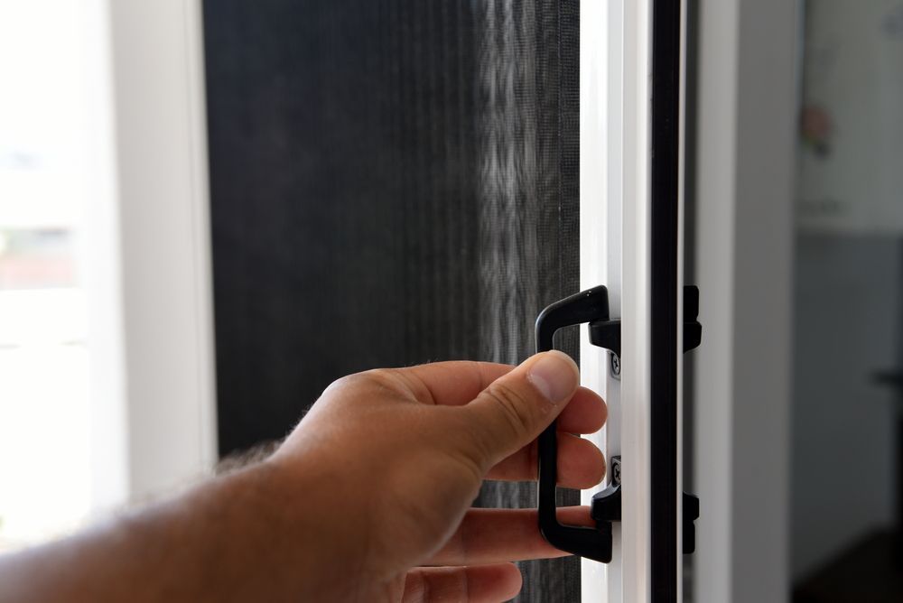 Man Closing Sliding Screen — Coastal Screens & Glass in Bonny Hills, NSW