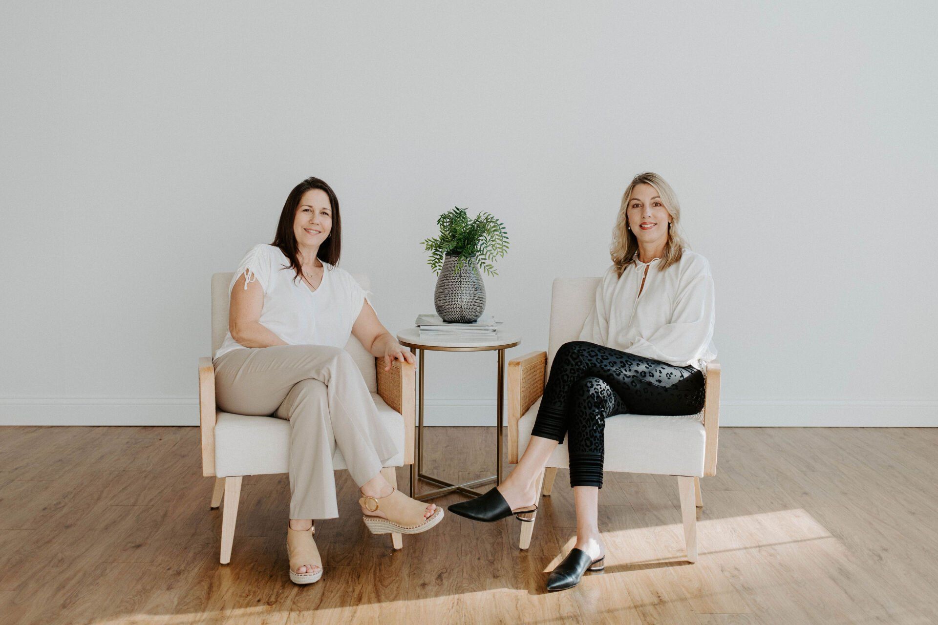 Kim and Jane from Metro NeuroHealth are sitting in chairs next to each other in a room.