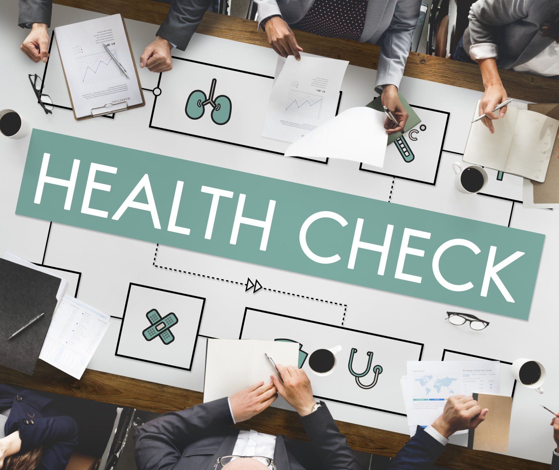 people sitting at a table reviewing a health check map