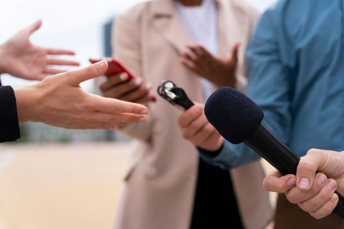 A group of people are holding microphones and talking to each other.