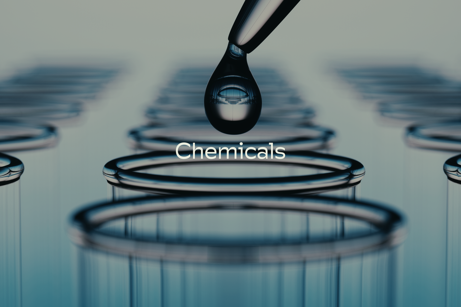 A drop of liquid is being poured from a pipette and the word chemicals is on the bottom