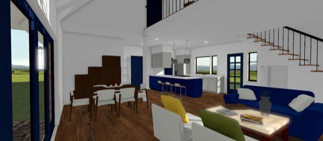 Modern living room with blue sofas, wood floors, fireplace, and a loft staircase in a bright open home