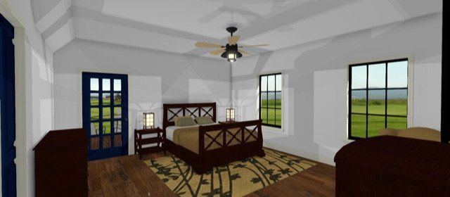 Bright bedroom interior with a bed, ceiling fan, patterned rug, and large windows overlooking green fields