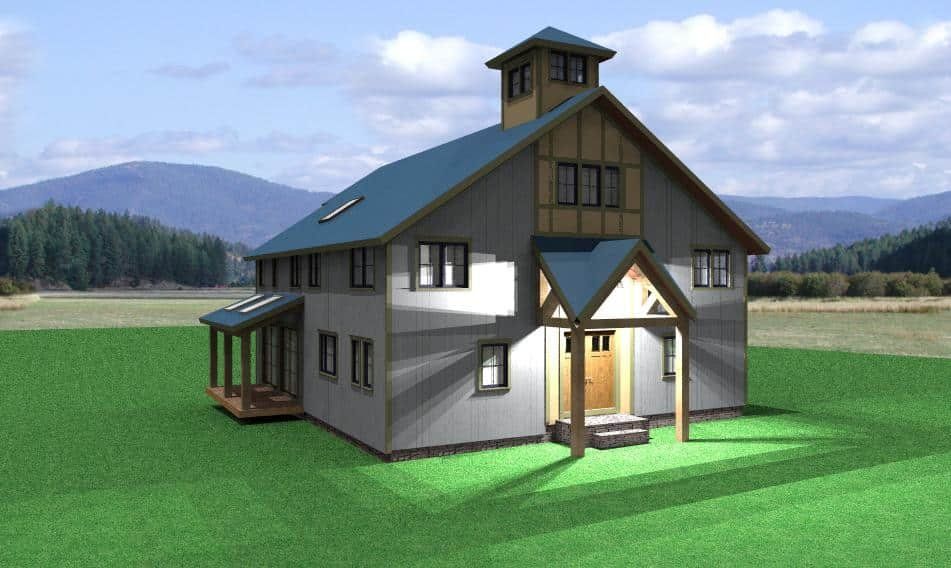 Two-story house with a porch and tower on a green field, with mountains in the background.