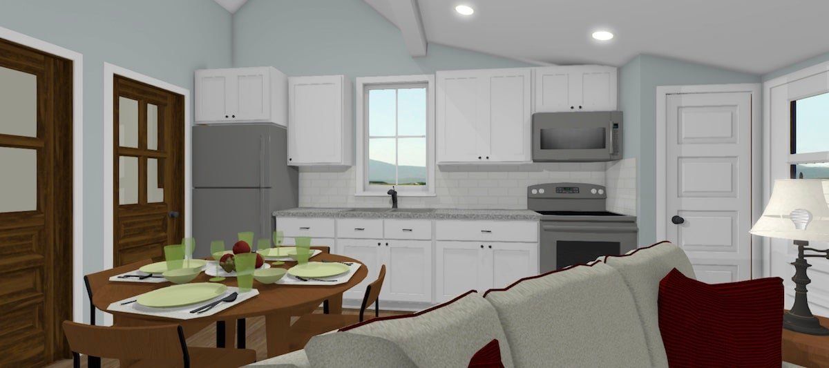 Open-plan kitchen and dining area with white cabinets, gray appliances, and a set dining table