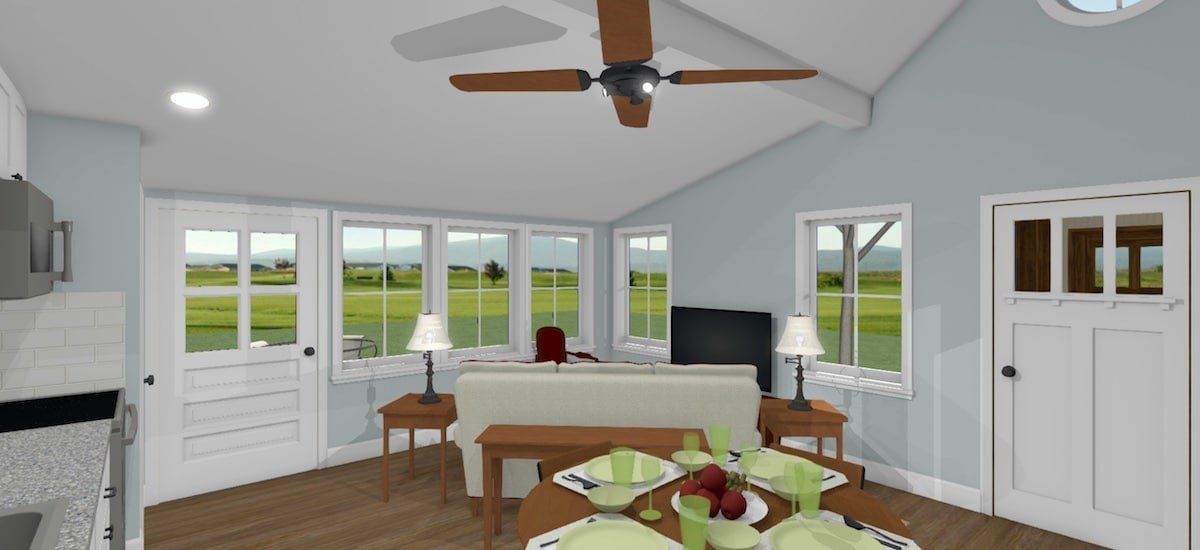 Bright sunroom with white walls, wood floors, large windows, a desk, and a ceiling fan