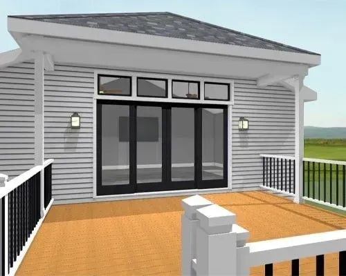 Modern house deck with black railings, double glass doors, and white siding beneath a gray roof.