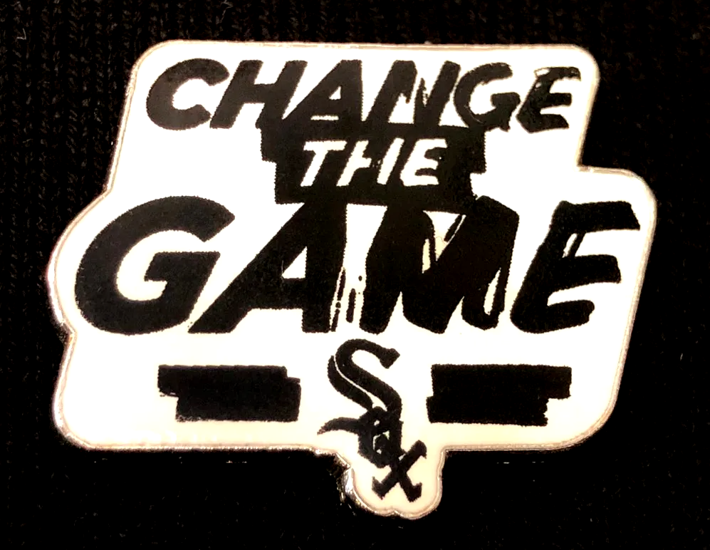 A pin that says change the game on it