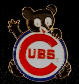 A chicago cubs pin with a black bear on it