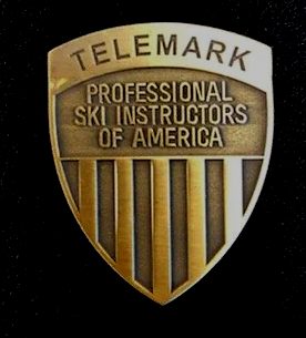 A badge that says telemark professional ski instructors of america