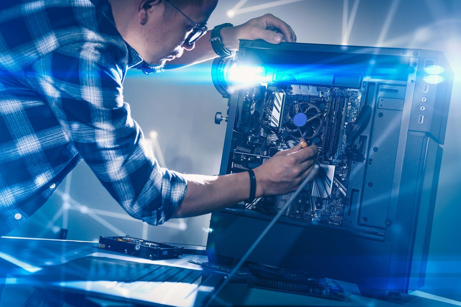 Man working on computer components, likely installing or repairing them.