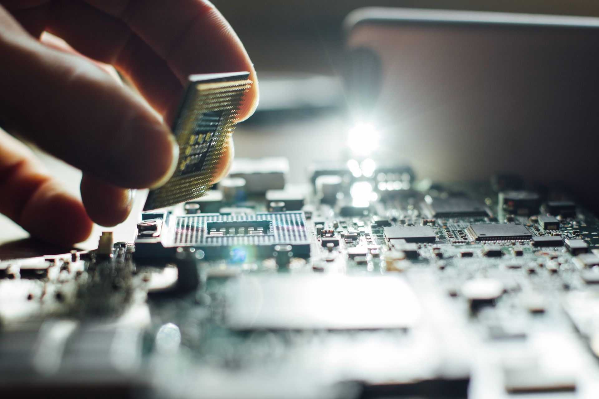 Hand placing a computer processor chip onto a motherboard.