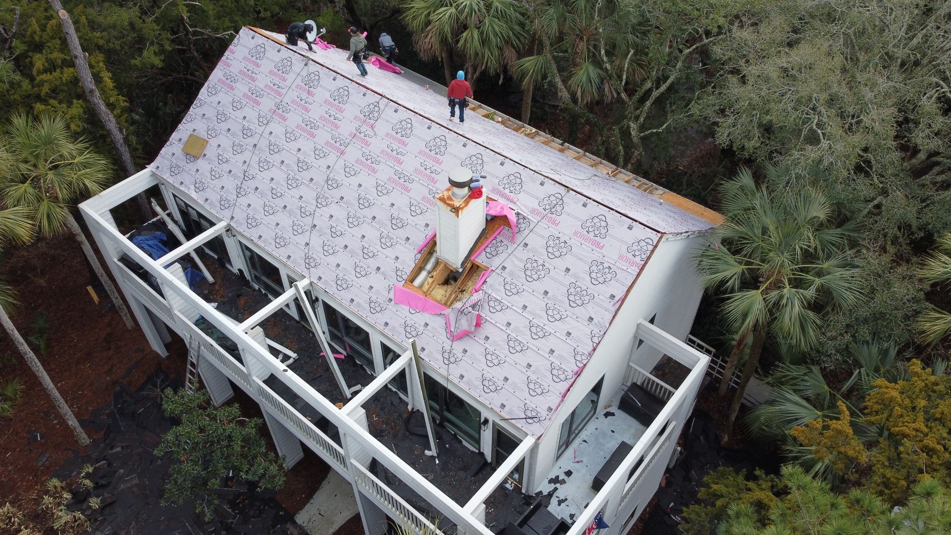 Underlayment installed on the white porch house during replacement
