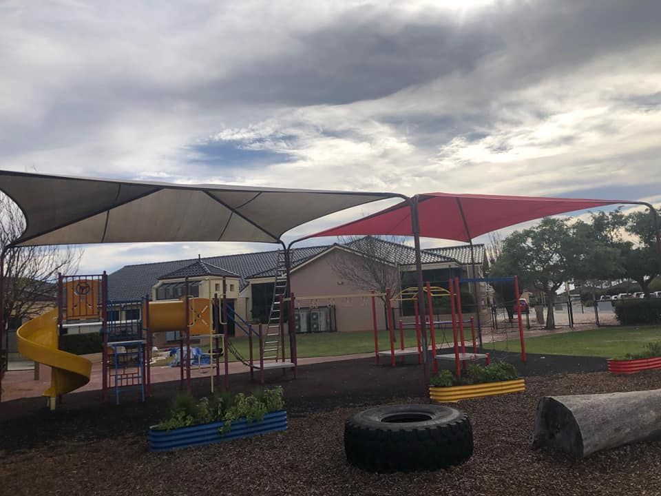 Kids playground with a large canvas shade canopy