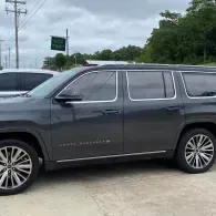 Dark gray SUV parked outdoors on a cloudy day.