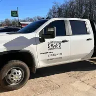 White work pickup truck with company logo parked outdoors on a sunny day