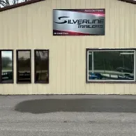 Silverline Trailers storefront with beige siding, large windows, and a sign above the entrance.