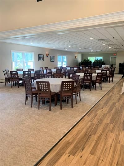 A large room with tables and chairs in it.