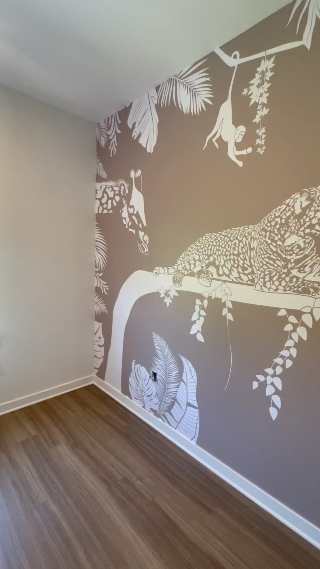 A room with a painting of a leopard on the wall.