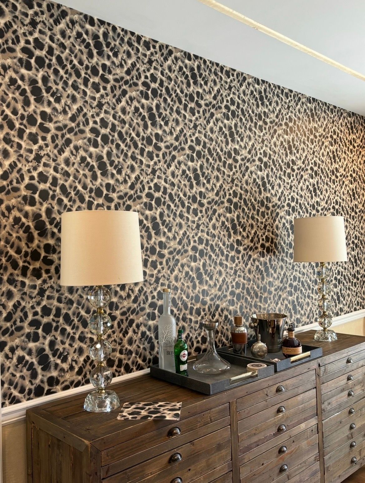 A room with a black door and a brick wall