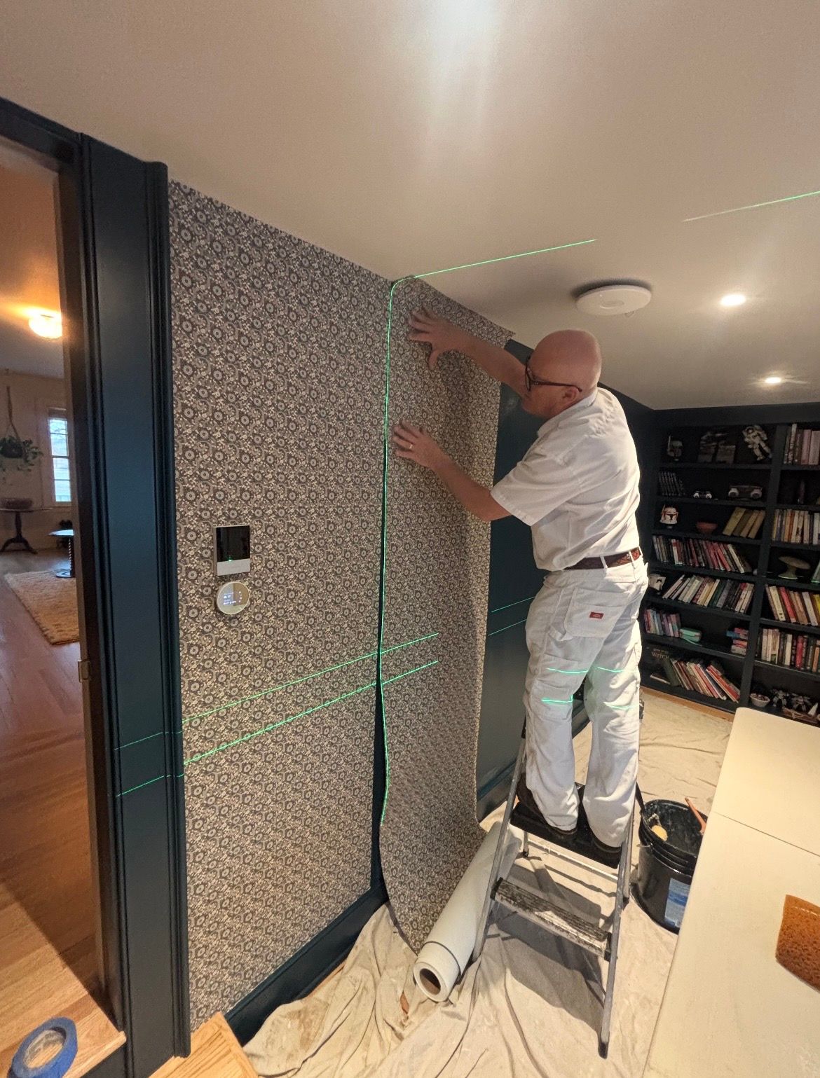 Three white orchids are growing in a wooden planter
