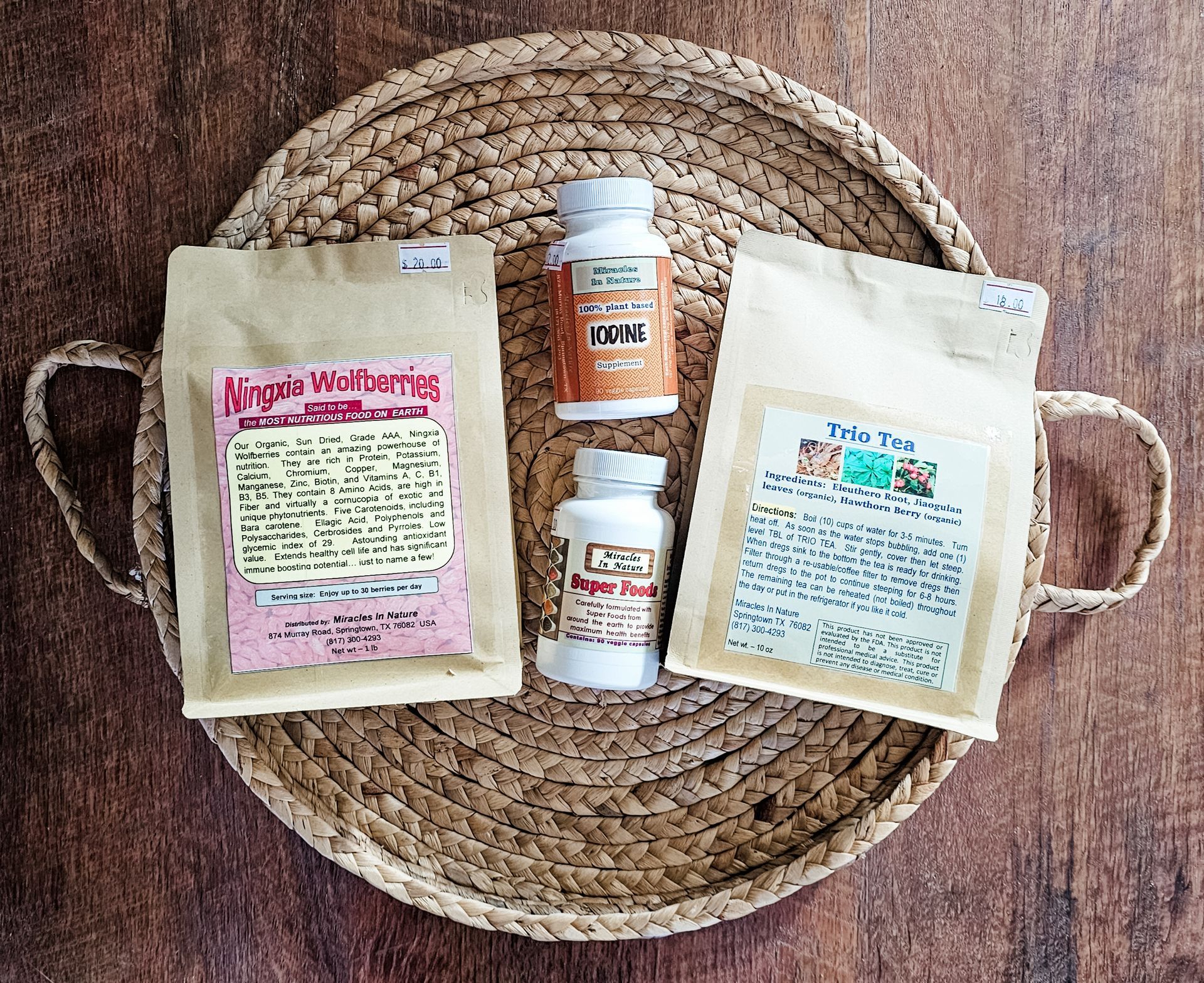 A wicker tray with a bag of african wildberries and two bottles of pills on it.