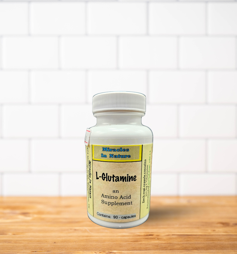 A bottle of l-glutamine is sitting on a wooden table.