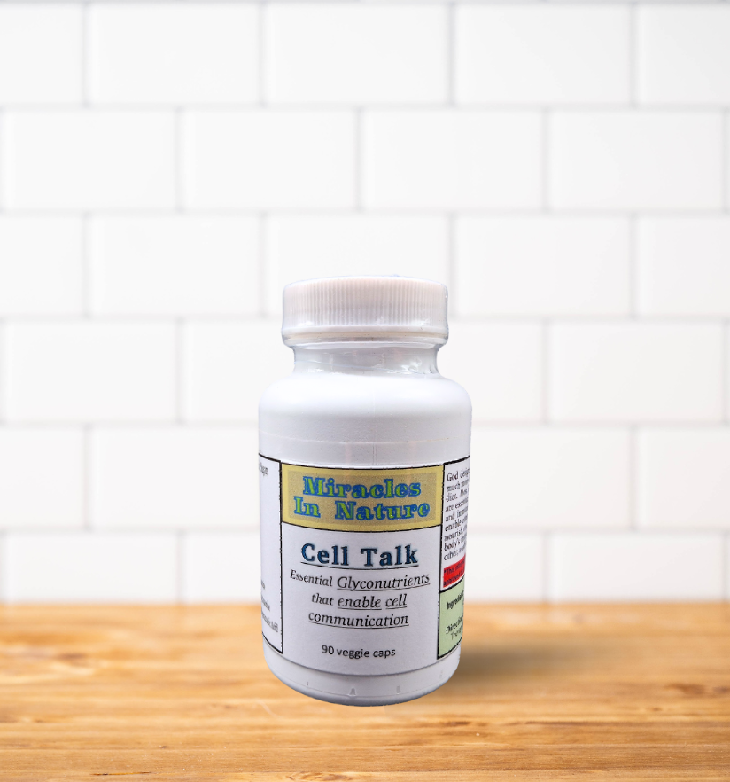 A bottle of cell talk is sitting on a wooden table.