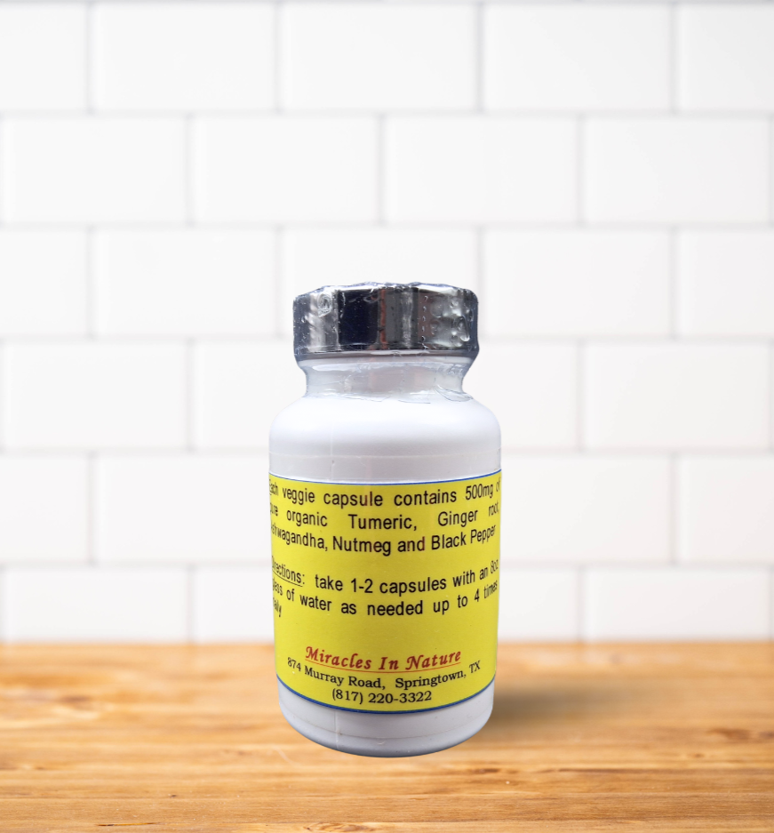 A white bottle of pills is sitting on a wooden table.