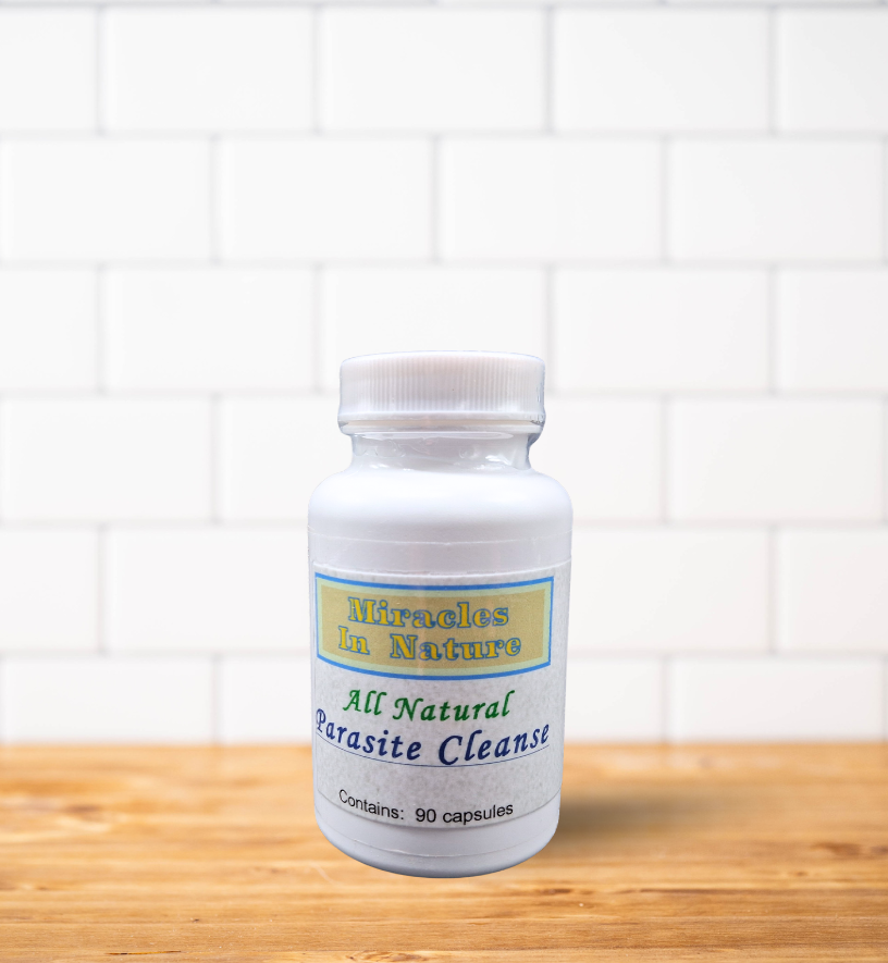 A bottle of all natural parasite cleanser is sitting on a wooden table.