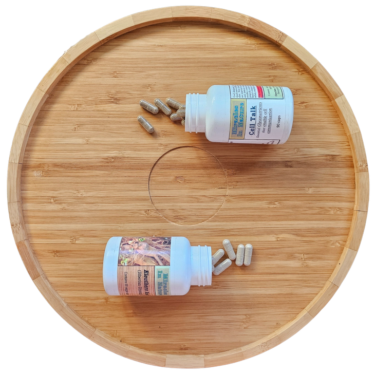 Two bottles of pills are on a wooden tray.