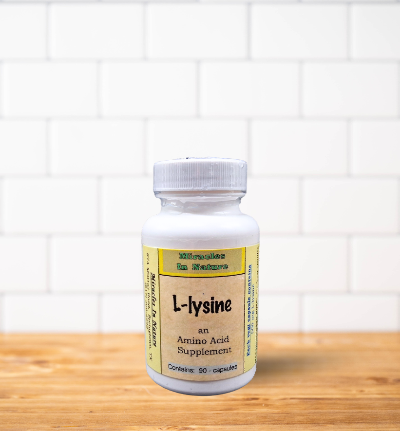 A bottle of l-lysine is sitting on a wooden table.